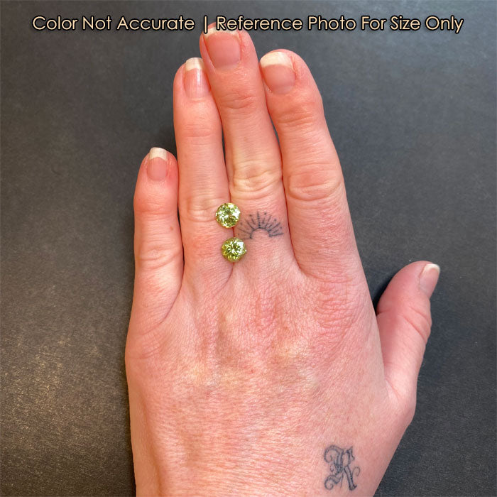peridot gemstone pair on hand