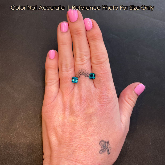 blue zircon gemstones on hand size square step cut