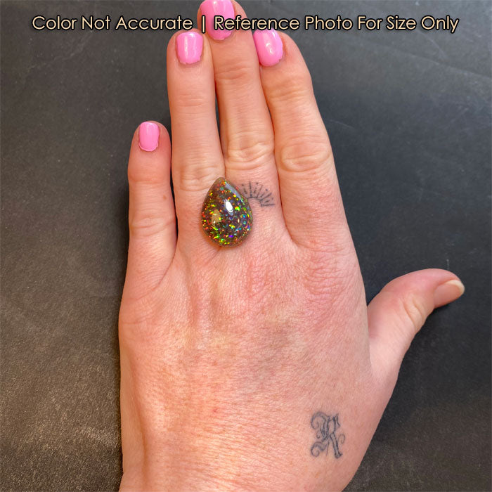 large black opal gemstone on hand