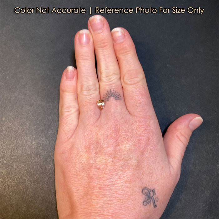 pear shape tourmaline on hand
