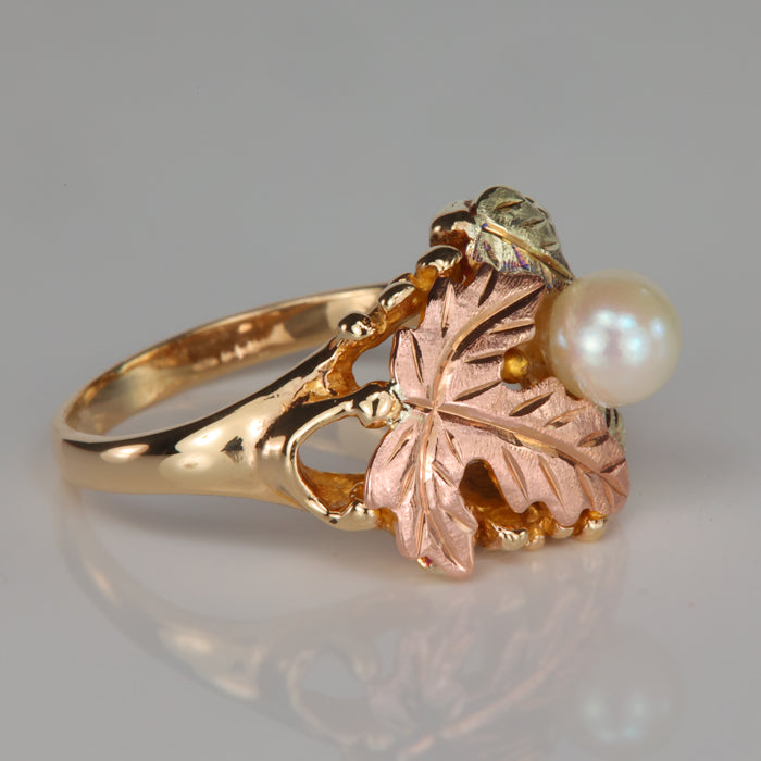pearl accented ring with leaf design yellow and rose gold