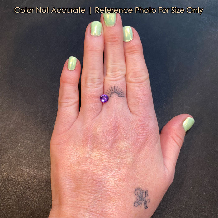 round brilliant violet pink sapphire gemstone on hand
