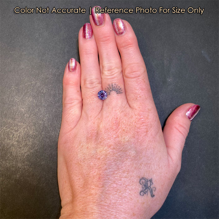 round purple spinel on hand