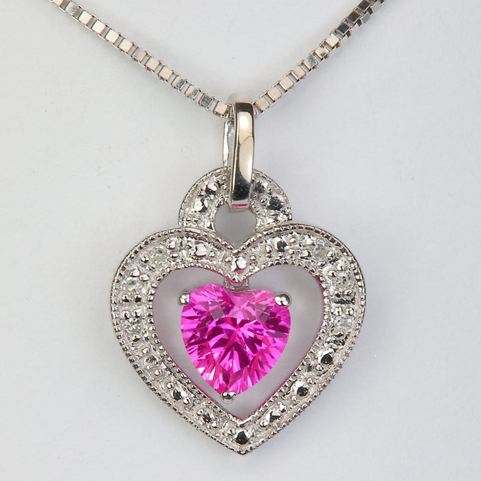 white gold and pink synthetic sapphire heart pendant with diamond accents