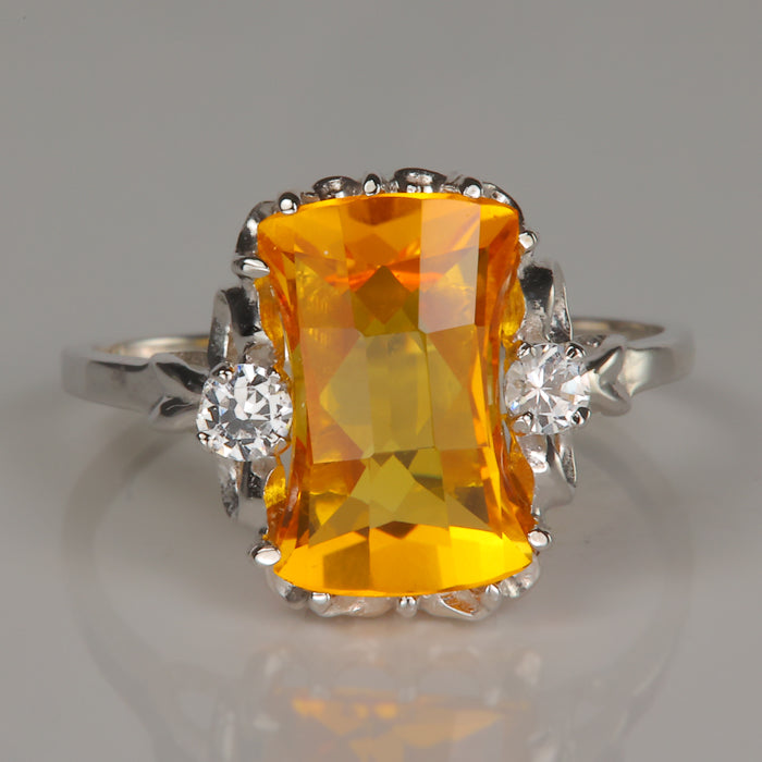 yellow orange synthetic sapphire ring with synthetic white spinel