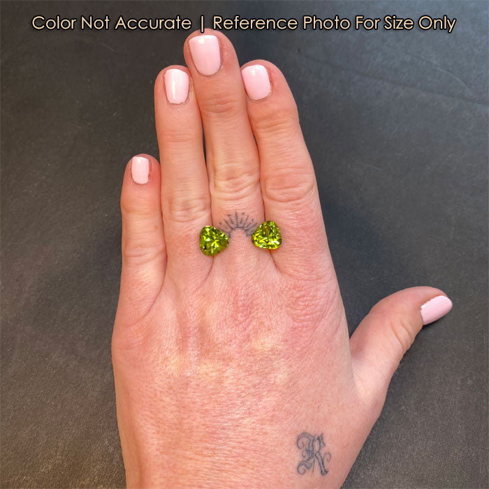 size of trilliant cut peridots to a hand