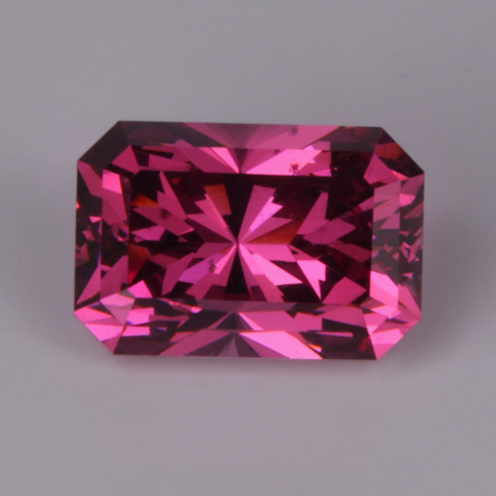 brilliant style emerald cut violet red umbalite garnet gemstone