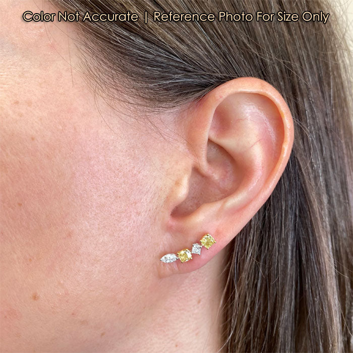 gold and diamond earrings on ear