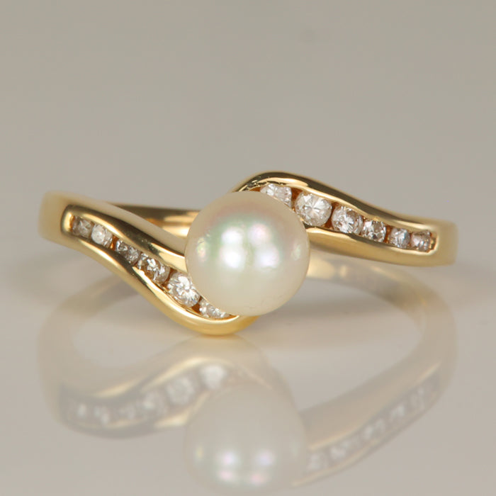 gold pearl ring with channel set diamonds