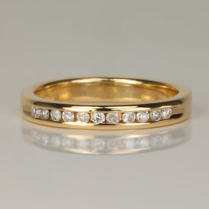 yellow gold round cut channel set diamond band