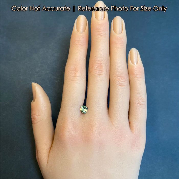 green shield demantoid garnet on hand