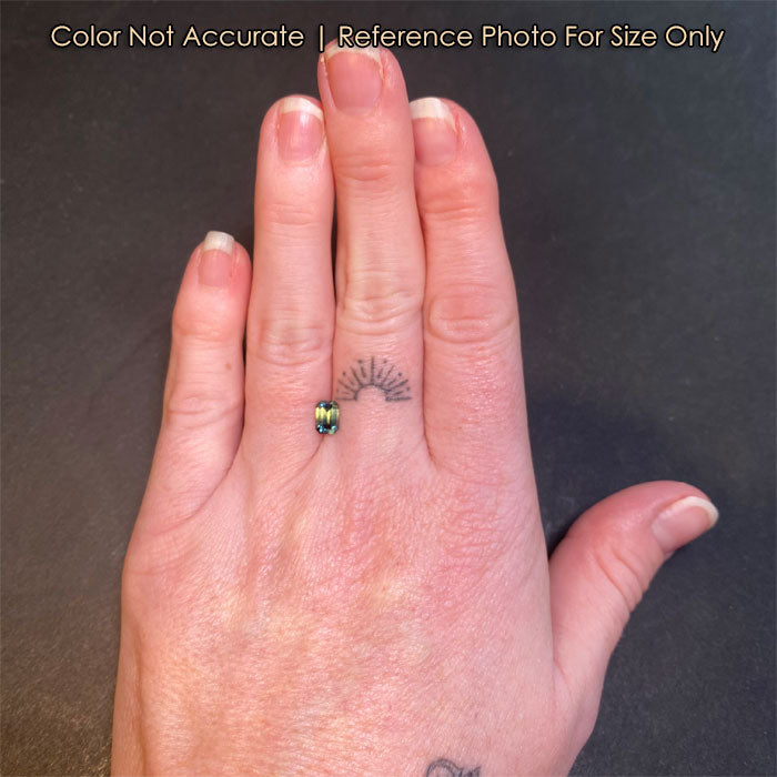 bicolor sapphire gemstone on hand size reference