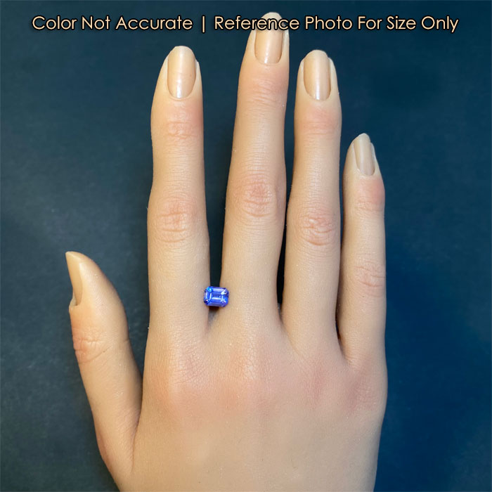 emerald cut sapphire gem on hand