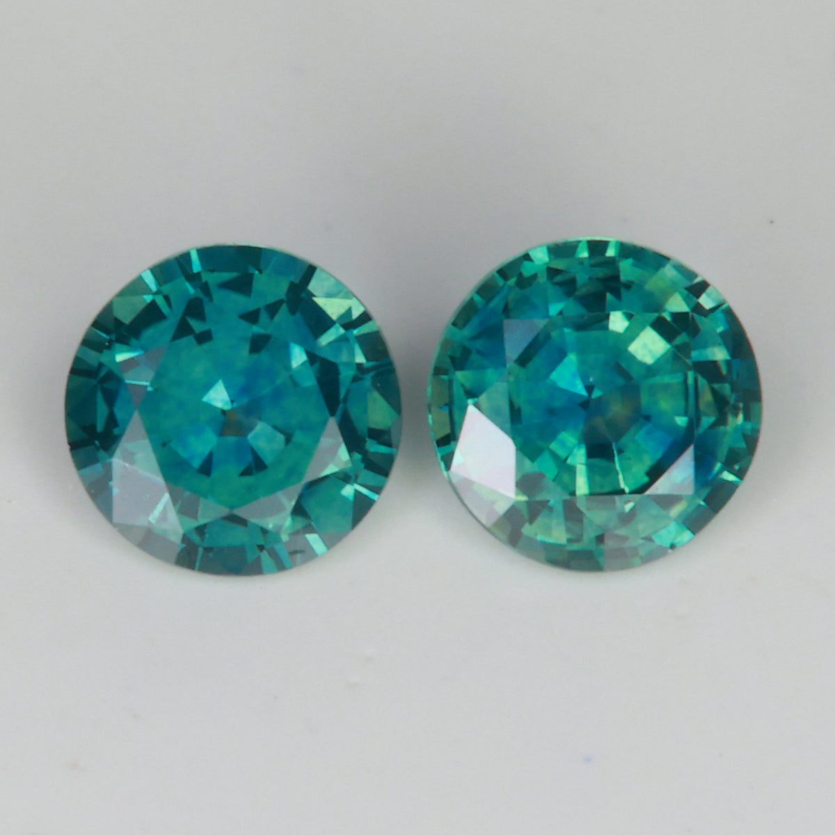 blue green round montana sapphire pair of gemstones