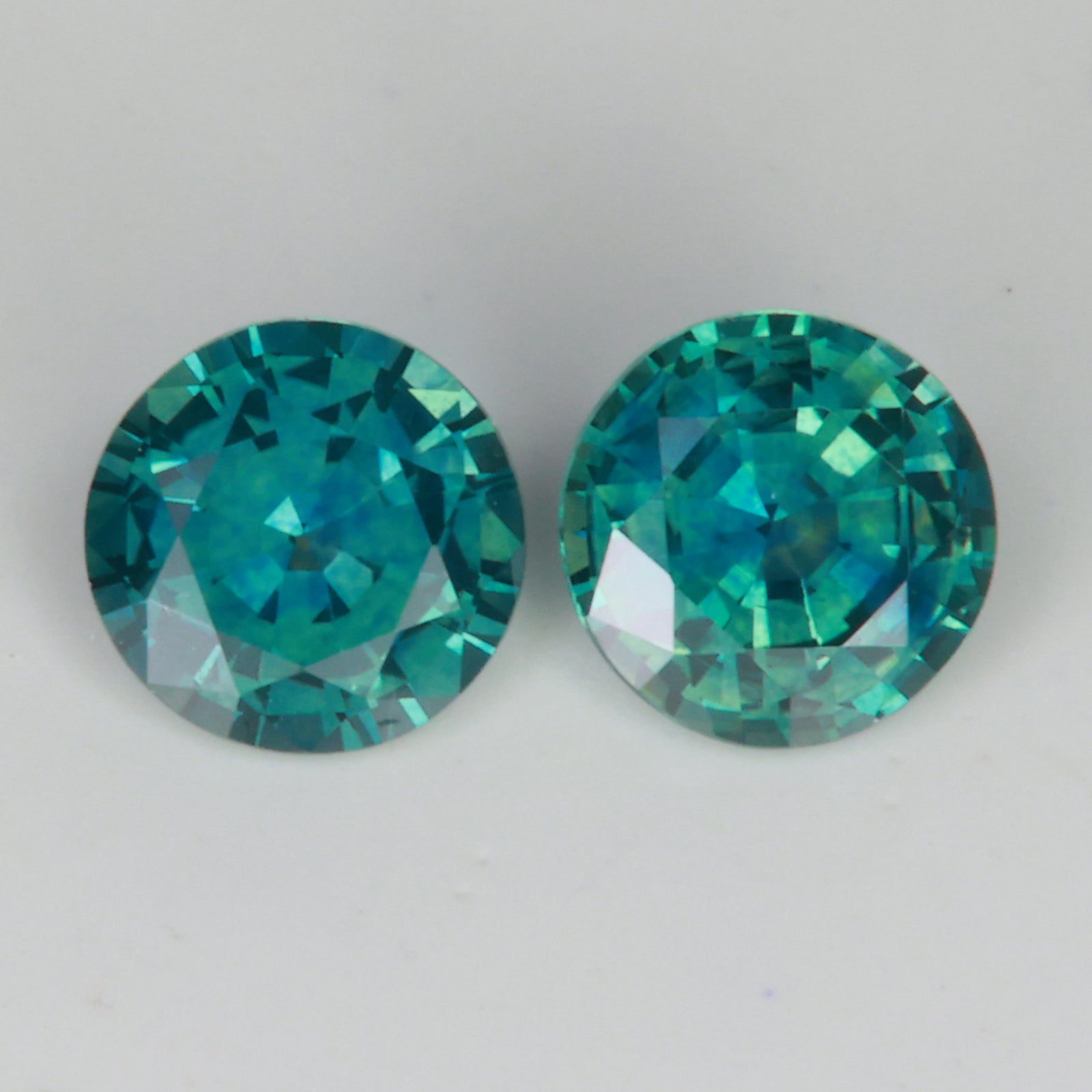blue green round montana sapphire pair of gemstones
