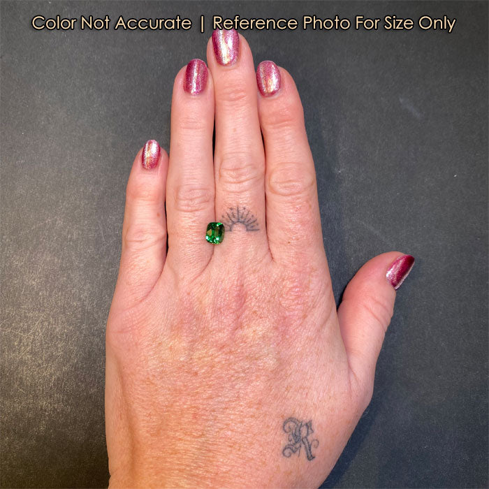 green color antique cushion tsavorite on hand