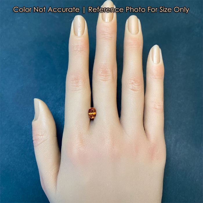 oval cut orange garnet on hand