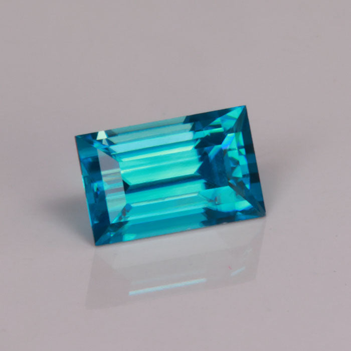 rectangular step cut greenish blue zircon gemstone