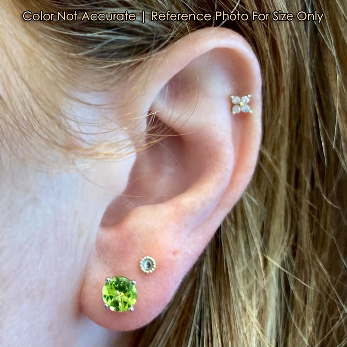 peridot stud earrings in white gold on ear