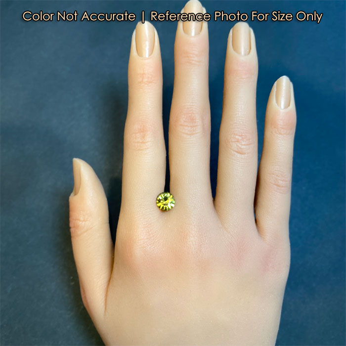 greenish yellow mali garnet gem on hand