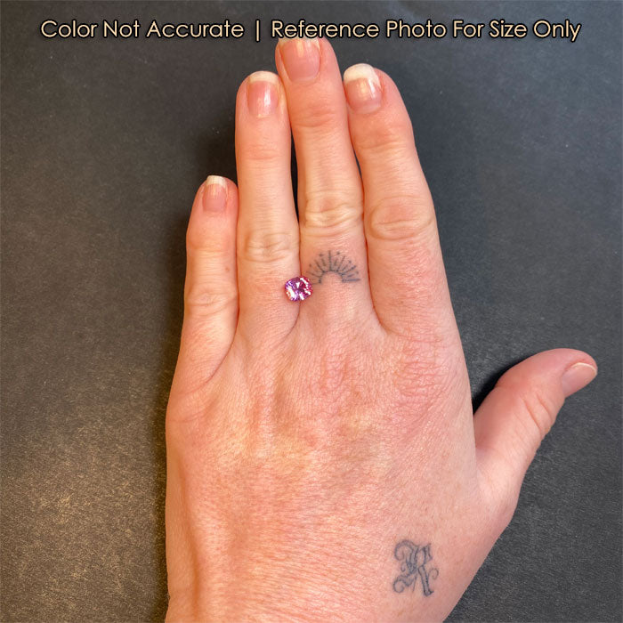 size reference of pink sapphire on hand
