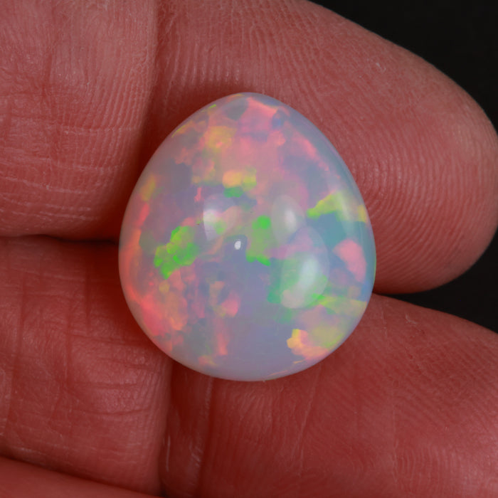 pear shape opal gem in hand 
