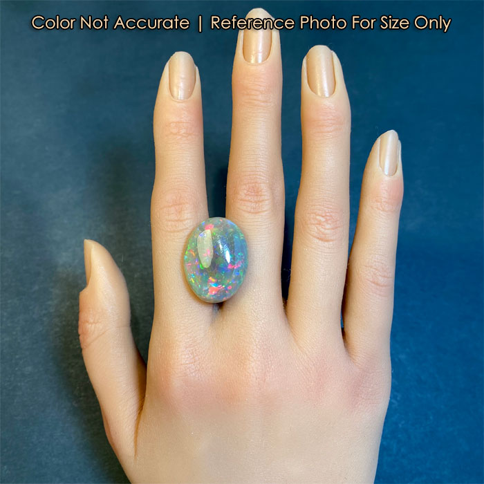 semi black opal gem on hand