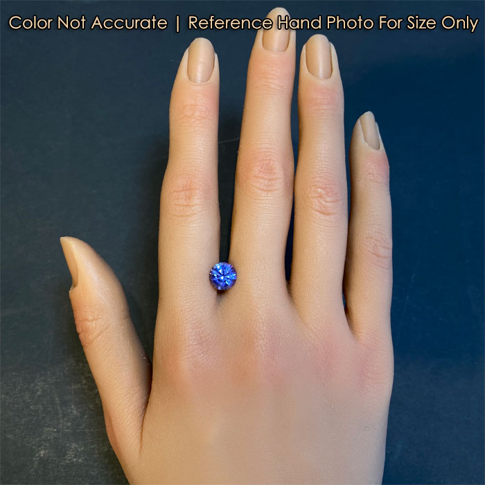 round brilliant tanzanite gem on hand