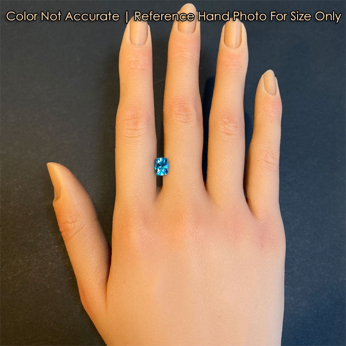 blue zircon gemstone on hand