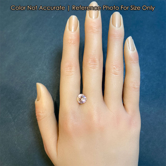 peach color tourmaline gem on hand 
