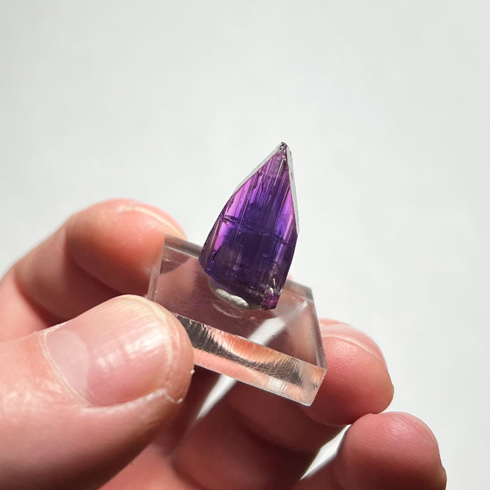 natural pink and purple tanzanite specimen in hand
