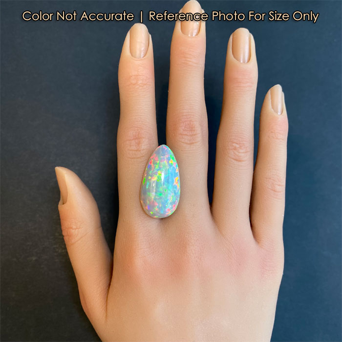 semi black pear shape opal on hand