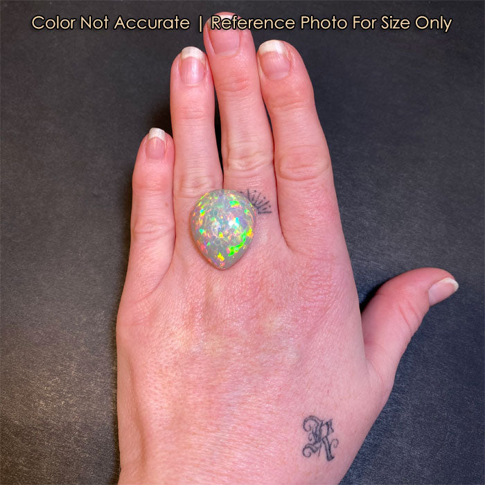 pear shape large opal gem on hand size reference