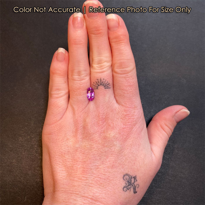 pink oval sapphire on hand size reference