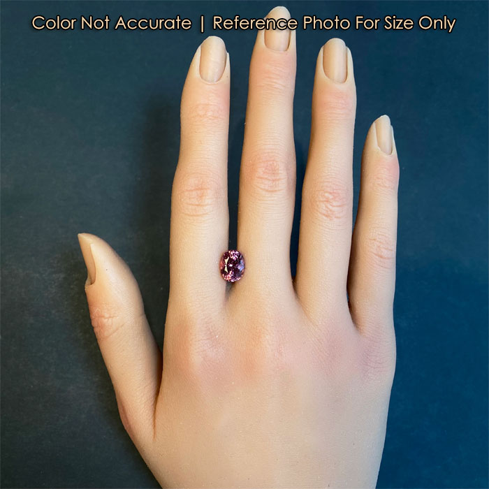 oval cut pink garnet gemstone size on hand