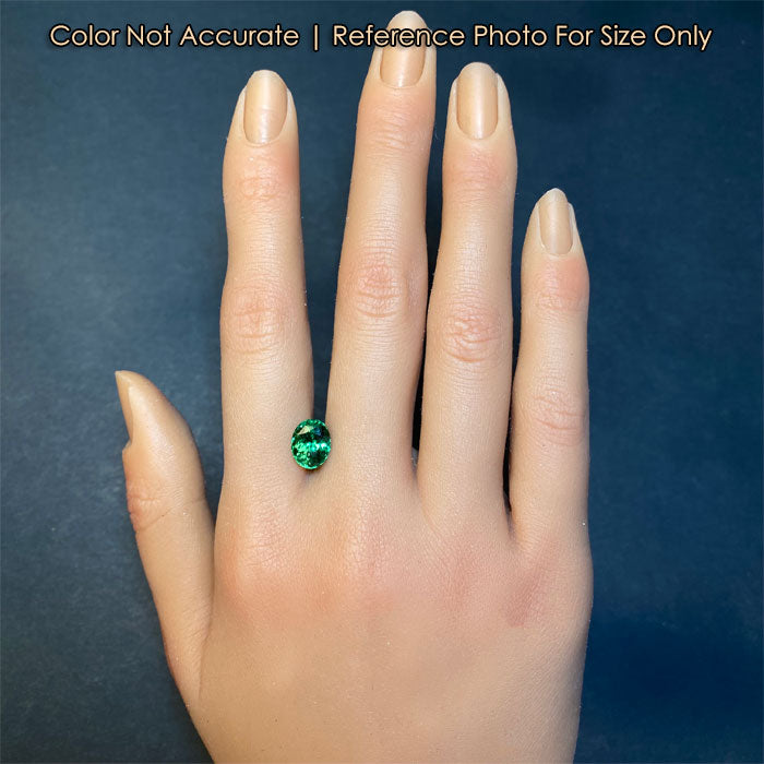 green oval garnet on hand for size