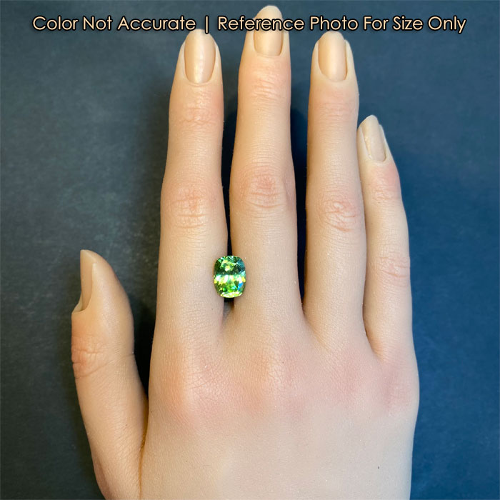 antique cushion green sphene on hand