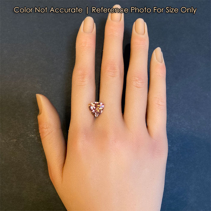 peach tourmaline gemstone on hand