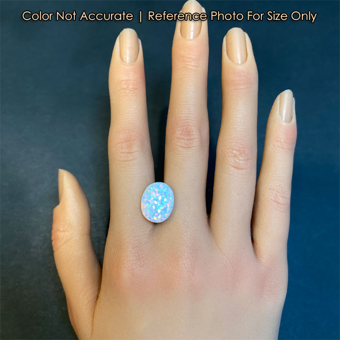 oval cabochon cut opal on hand