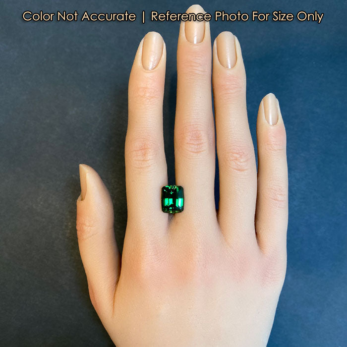 green tourmaline gemstone on hand