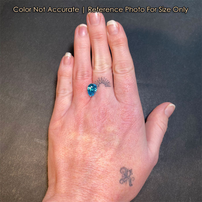 blue zircon gemstone on hand size