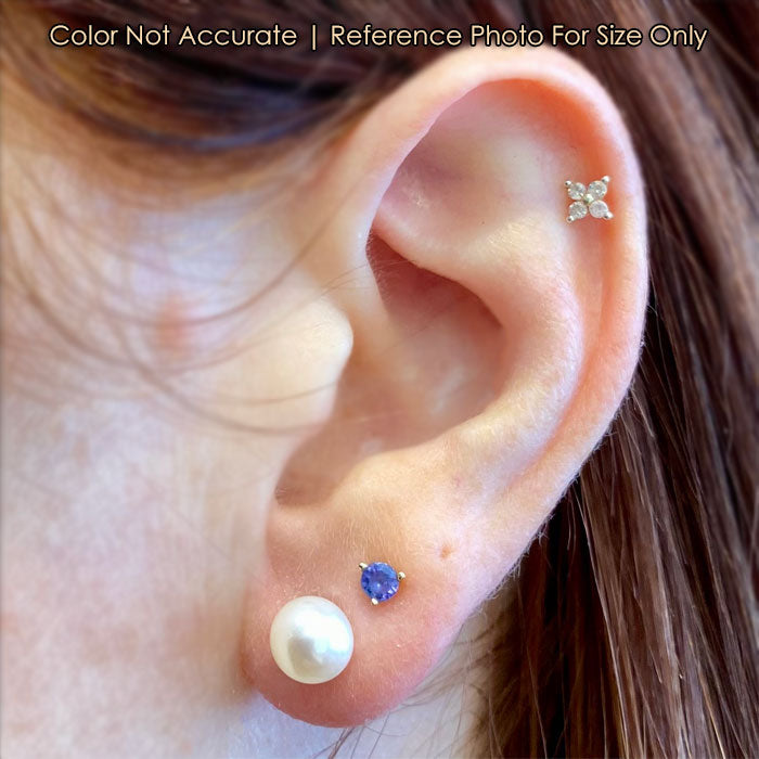 yellow gold pearl studs on ear