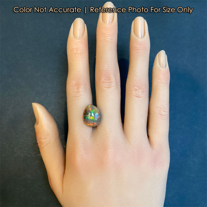pear shape black opal gemstone on hand