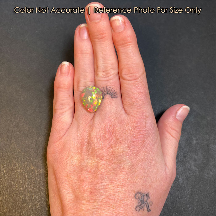 pear shape opal gemstone on hand reference