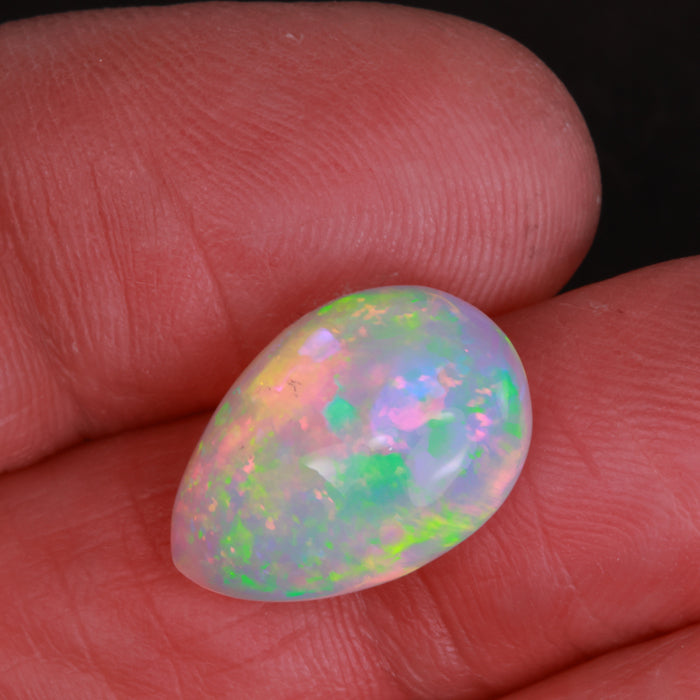 pear cabochon opal gem in hand