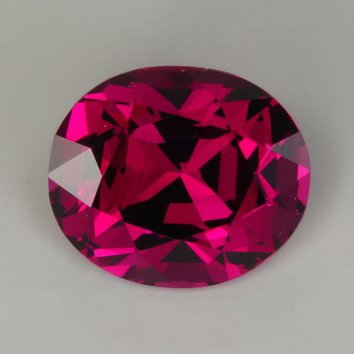 violet red oval cut garnet 