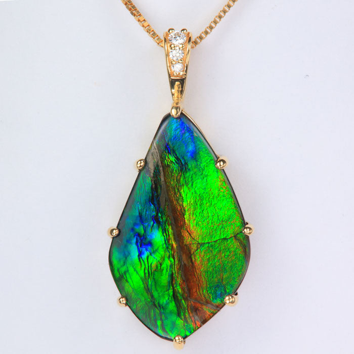 Multi color ammolite gem pendant with diamonds in yellow gold 
