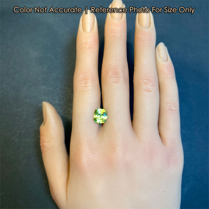 natural green sphene gemstone on hand 