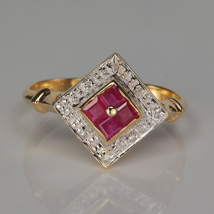 yellow gold ring with ruby and diamond in an art deco style 