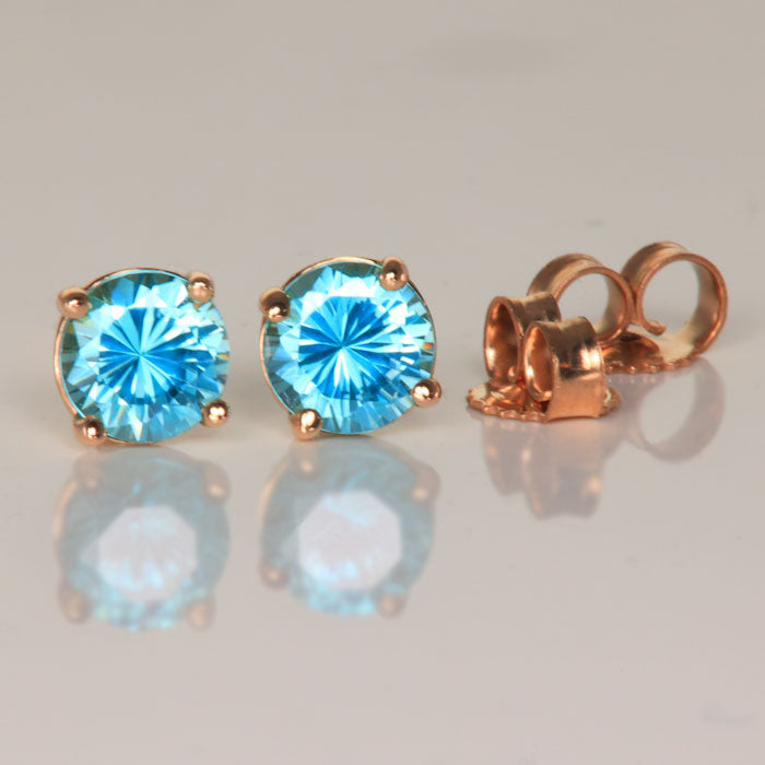 round cut blue zircon stud earrings yellow gold